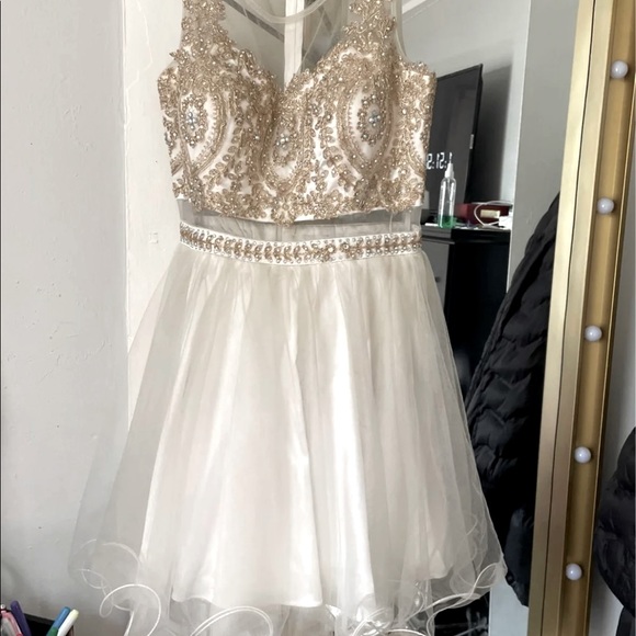 Beautiful beige dress with gold details on the top all around .